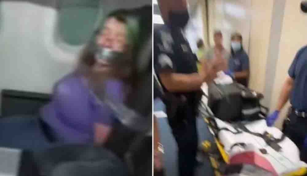 Uçuş sırasında uçağın kapısını açmaya çalışan kadını koli bandıyla bağladılar
