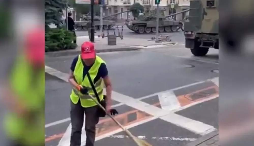 Rusya’da tanklar sokakta gezerken, işçi temizlik yapmaya devam etti